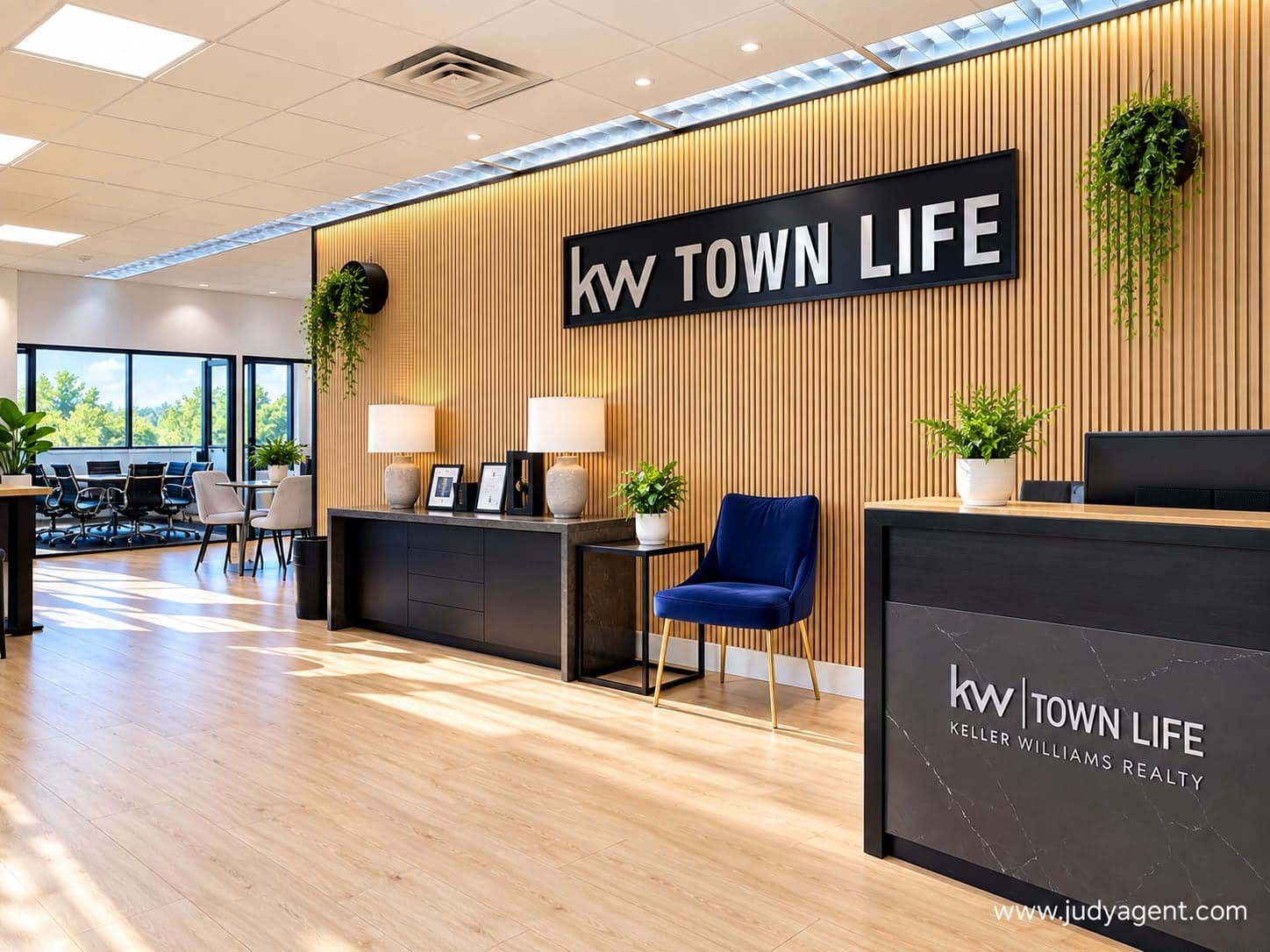 Reception area with a KW Town Life sign on a wood-slat wall and a front desk